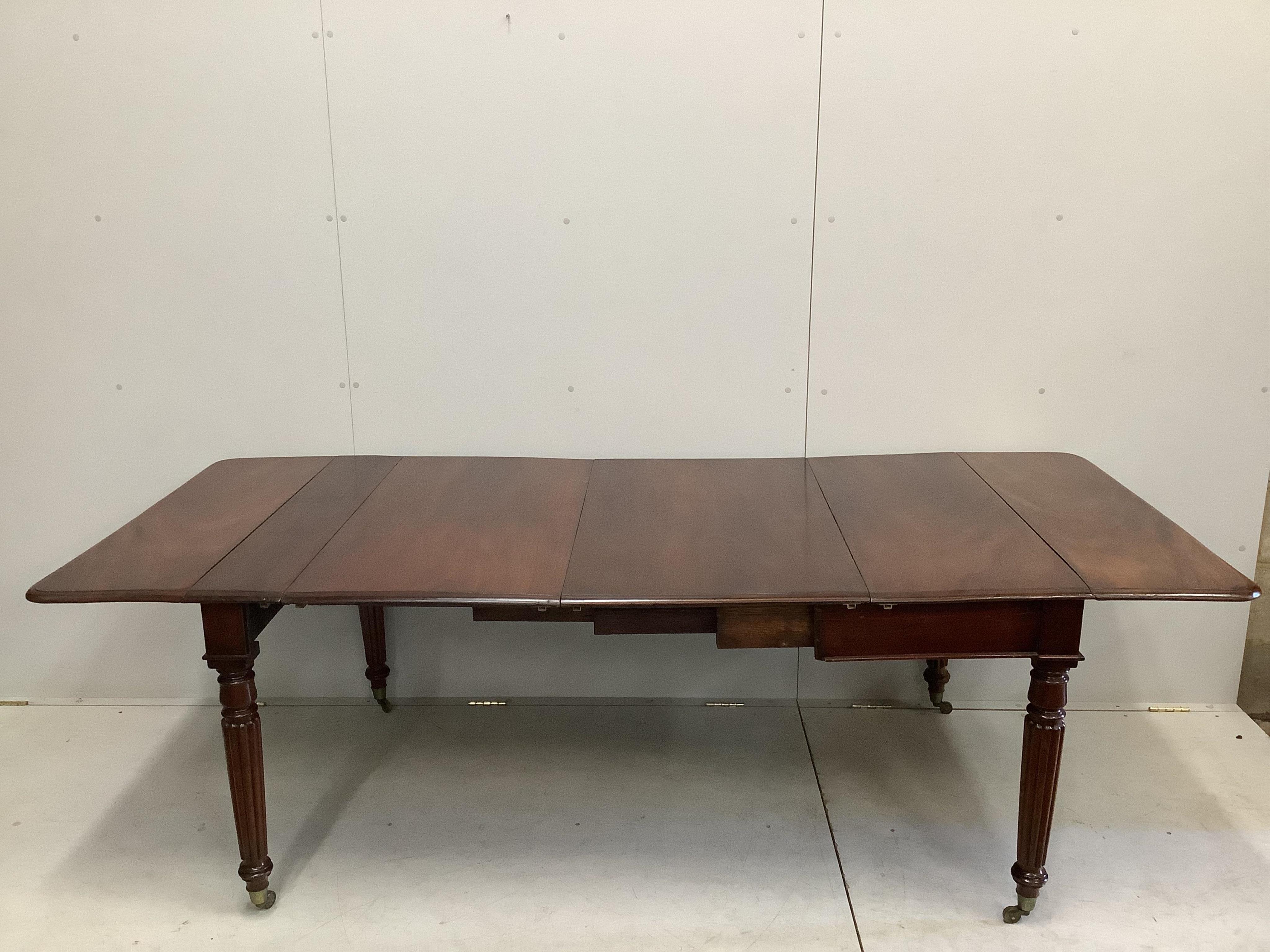 A George IV mahogany drop flap extending dining table, width 228cm extended, two spare leaves, depth 102cm, height 73cm
